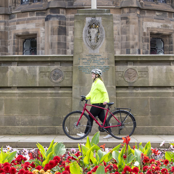 Alumni Officer Angharad Jones (LLB 2014), who commutes to work on two wheels, passes the beautiful floral displays at Gilmorehill.