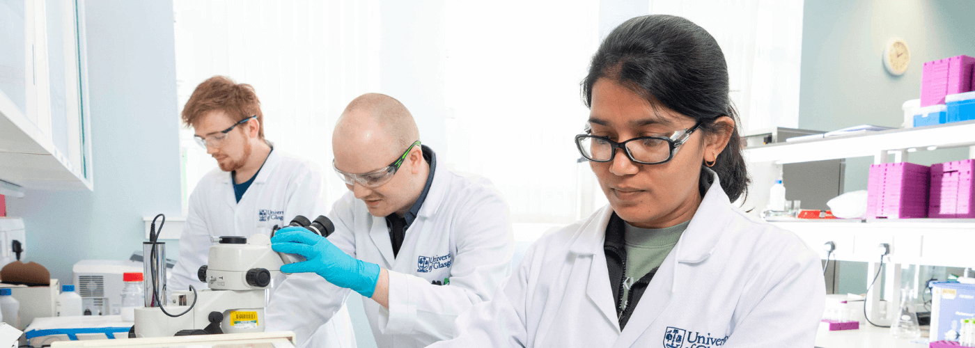 Three chemistry students working in lab