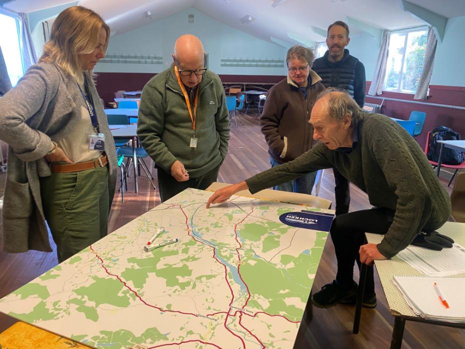 Image shows the Loch Ken team using a large map during the community planning sessions