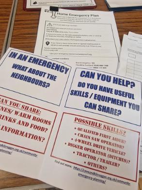 Image shows leaflets laid on table at community council meeting