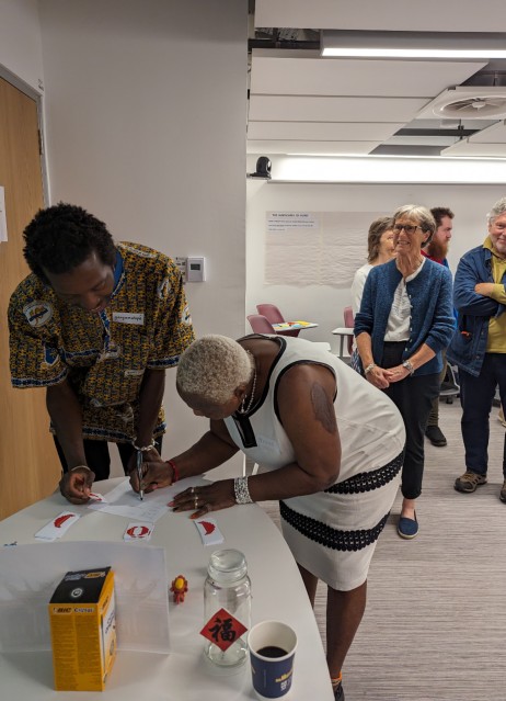 Workshop participants writing on a piece of paper