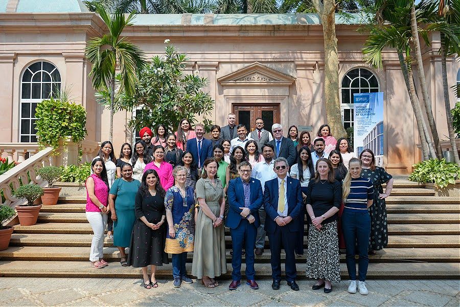 Delegation of visitors from Glasgow with partners in Mumbai posing for a group shot outside a building in the sunshine