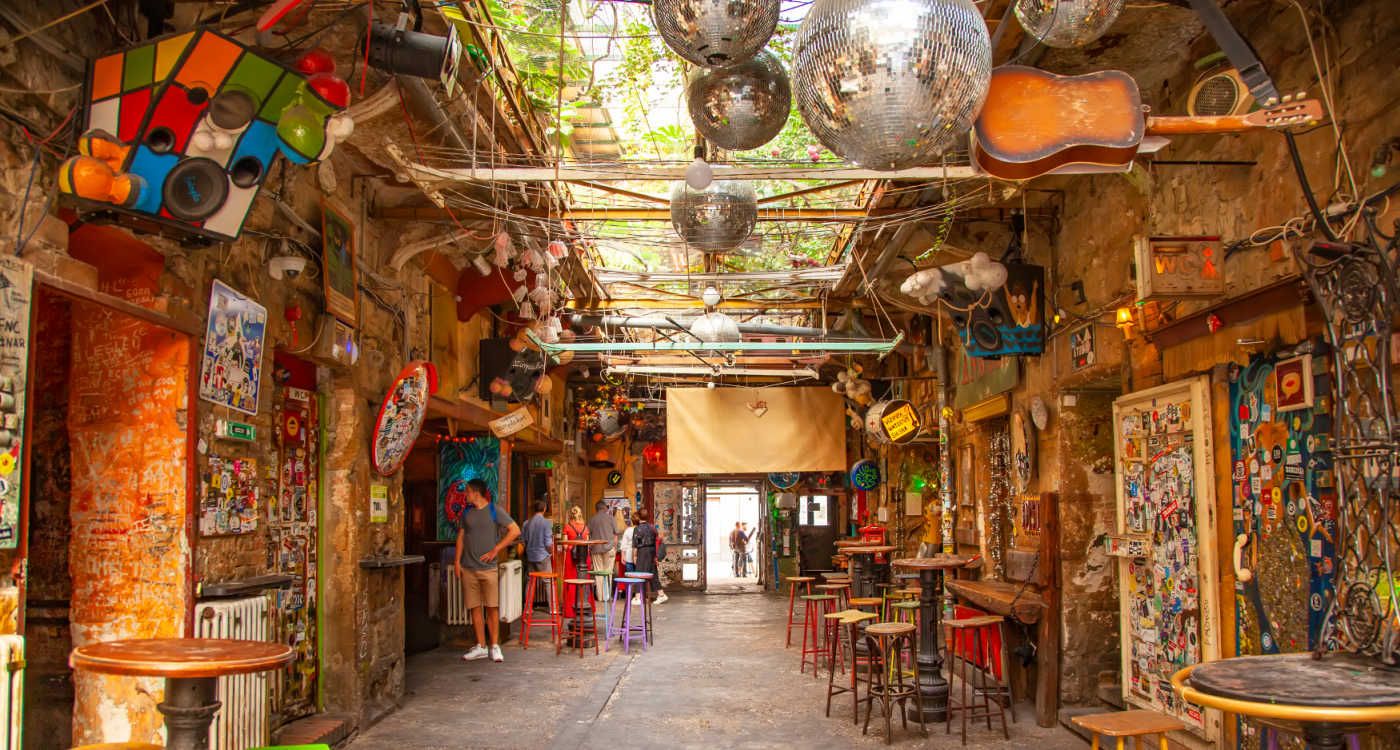 Szimpla Kert ruin bar interior in Budapest showing glitter balls and guitars on the ceiling [Photo: Shutterstock]