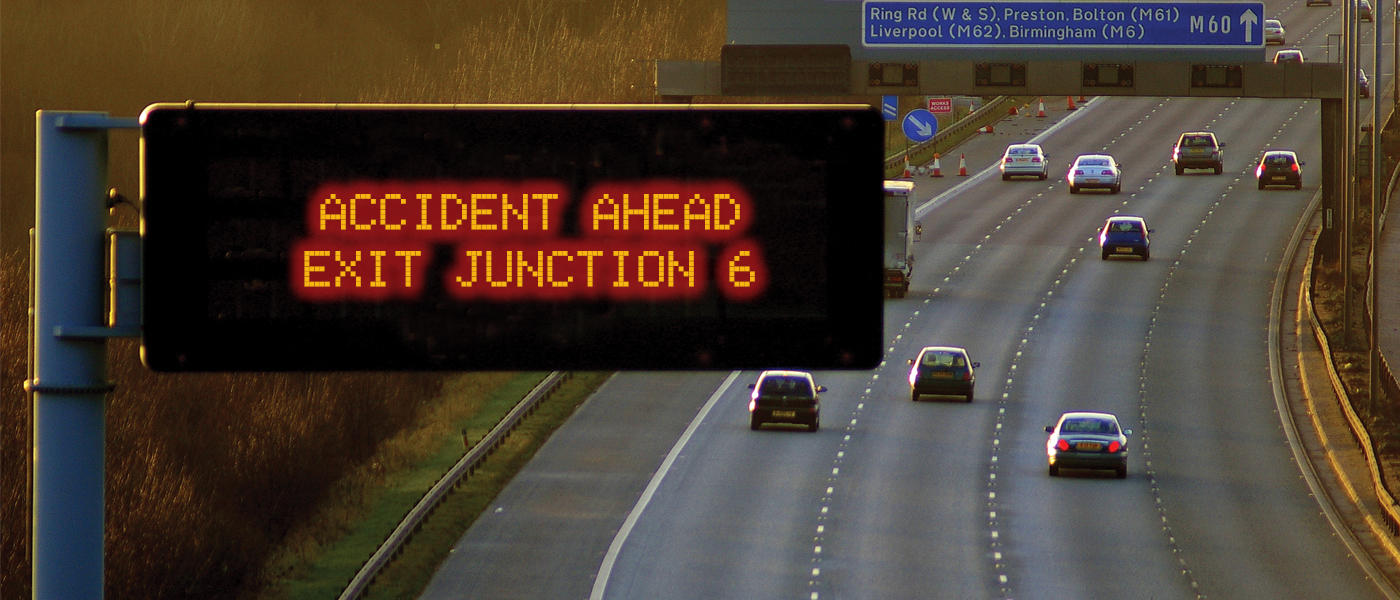 an arial image of a motorway with a road traffic sign