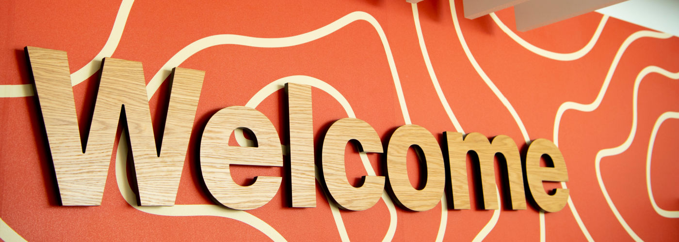 A photo of the welcome sign from inside the Clarice Pears building