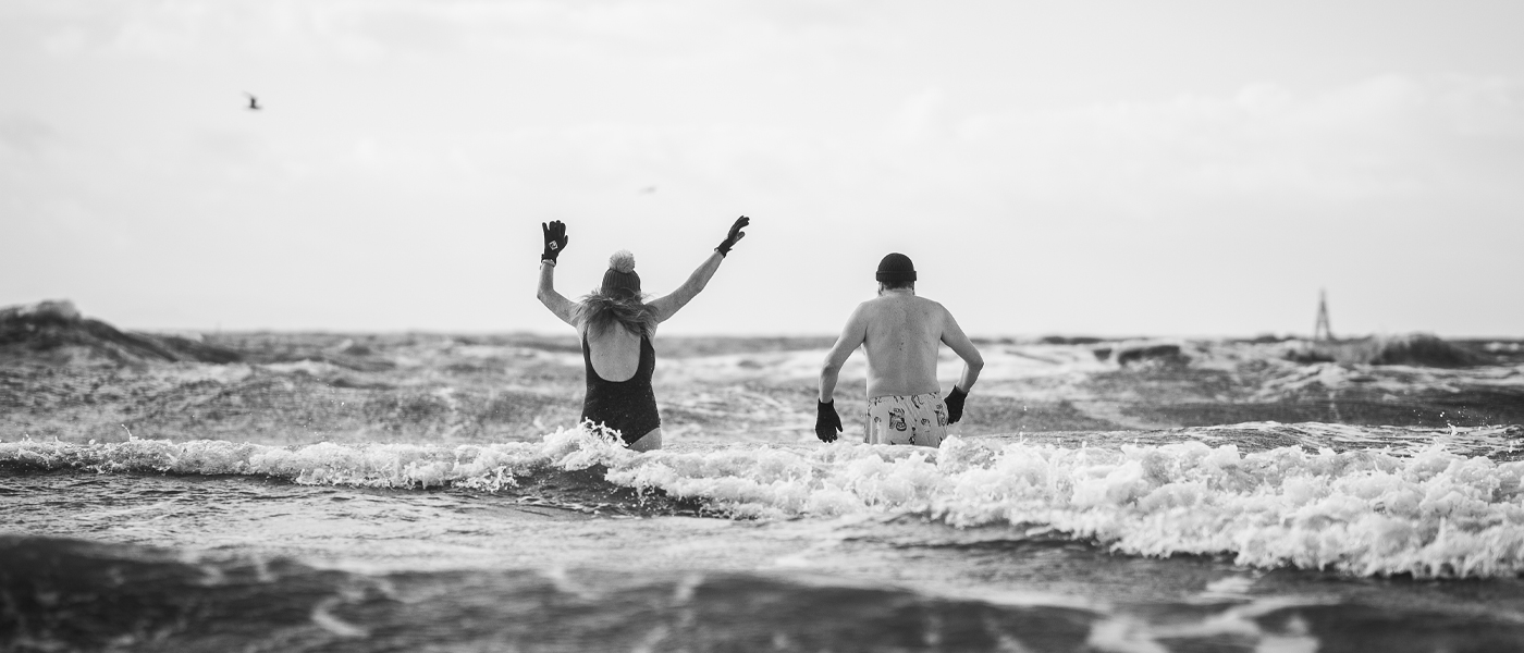 Black and white picture of Greg Hemphill and his wife Julie Wilson Nimmo wild swimming in the sea