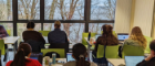SCAF colleagues writing inside with a view of Loch Lomond