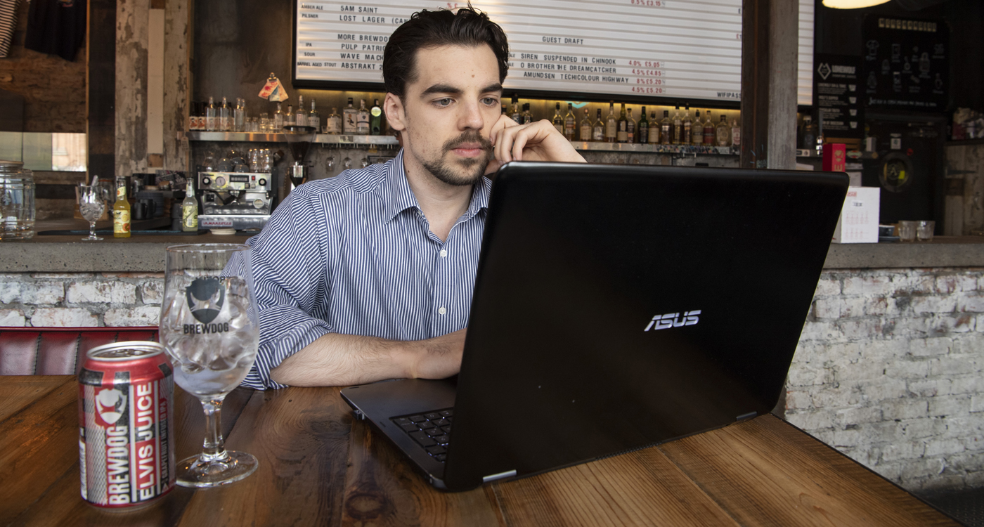 Eli Szydlo on a computer in Brewdog (photo: University of Glasgow Photographic Unit)