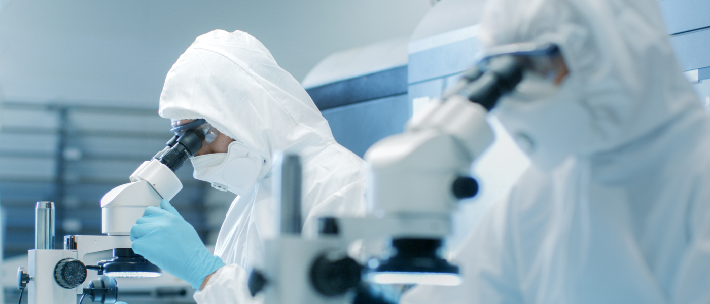 Scientists in a lab wearing protective clothing