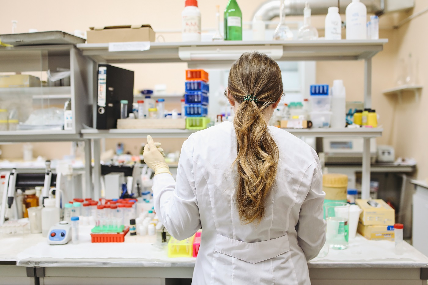 Woman In White Long Sleeved Laboratory Gown Standing SPLASH