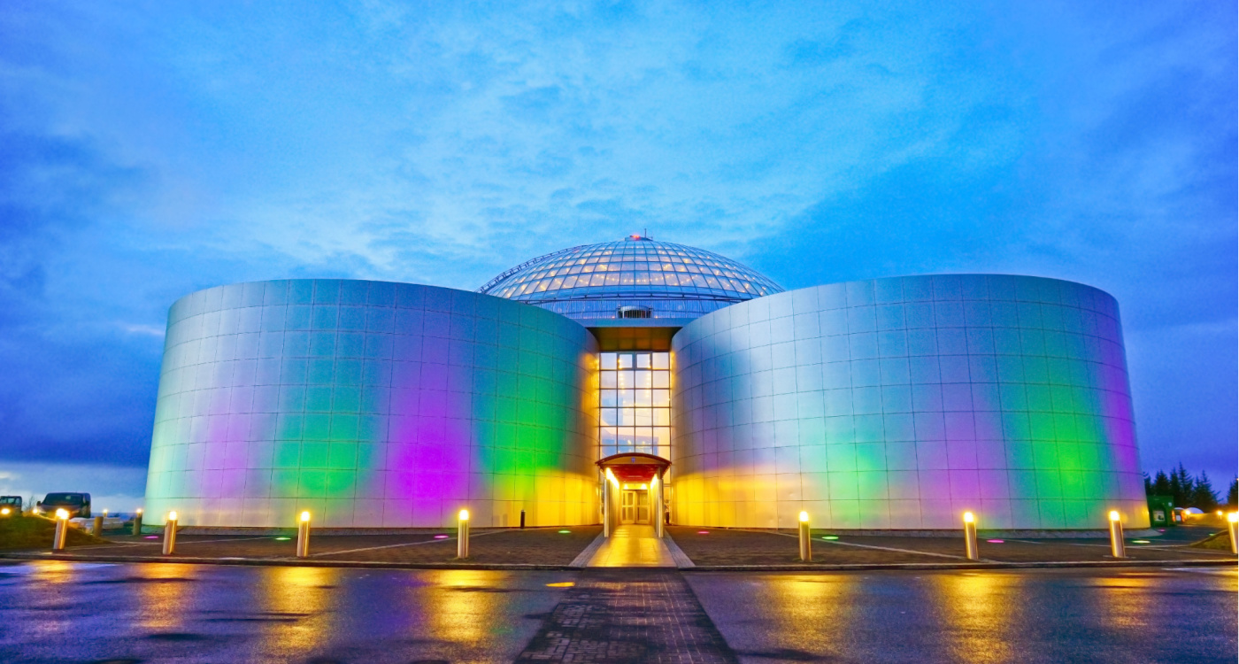 View of the exterior of the Perlan Museum in Reykjavik at night.