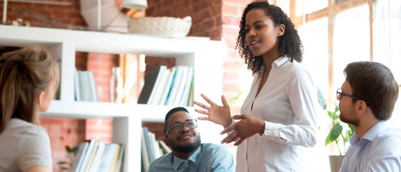 female employee speaking at informal meeting