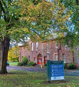 Maxwell House building with a tree in front