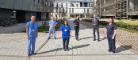 Six doctors and nurses standing outside the QEUH