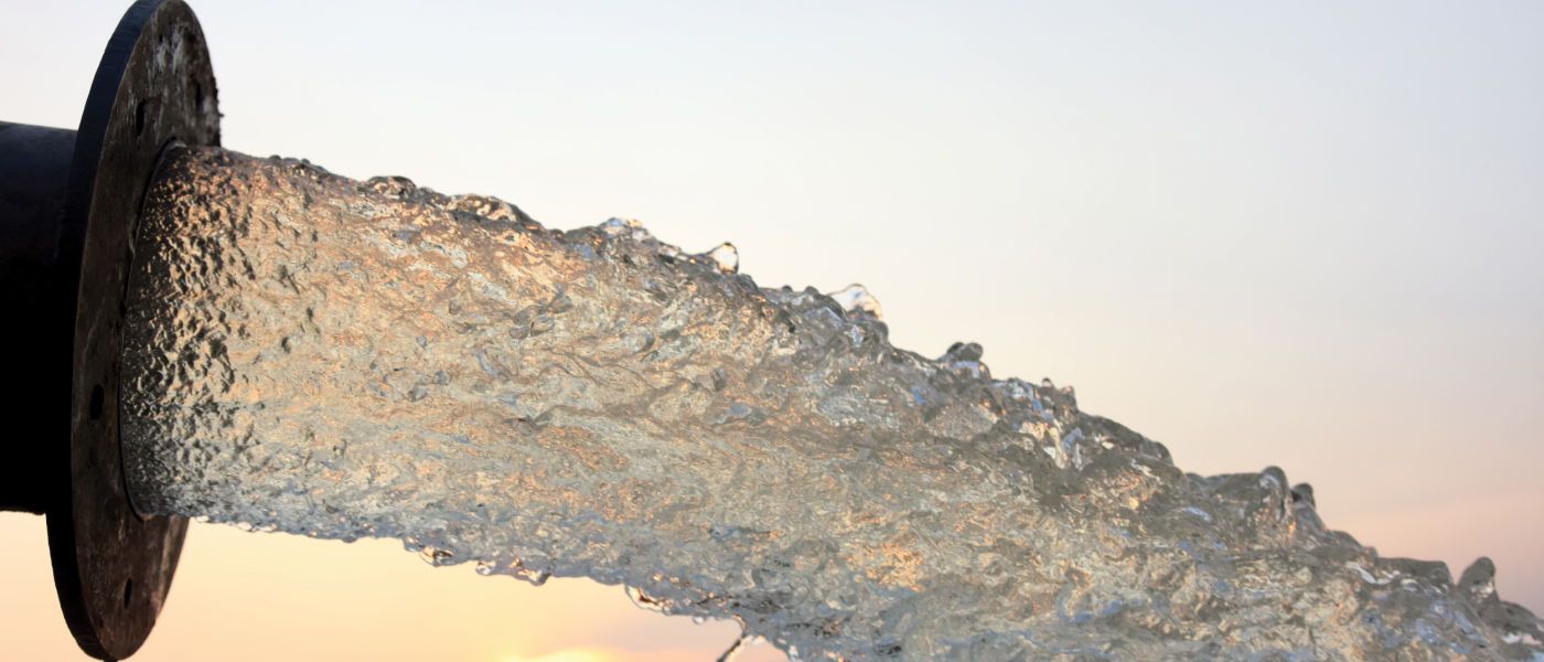 Water pouring out of a pipe outlet