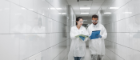 two scientists walking down a hallway