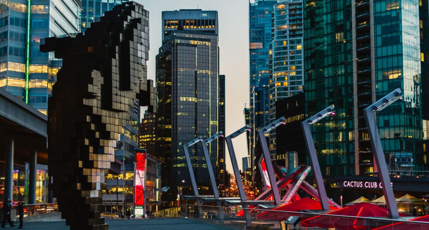 Digital Orca, an aluminium sculpture of an orca, with Vancouver city buildings in background [Photo: Aditya Chinchure, Unsplash]