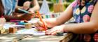 View of a child's hand drawing a picture with other children behind them Source: RawPixel Publisher: IstockPhoto Link: https://www.istockphoto.com/photo/group-of-kindergarten-kids-friends-drawing-art-class-outdoors-gm671259542-122840763?clarity=false