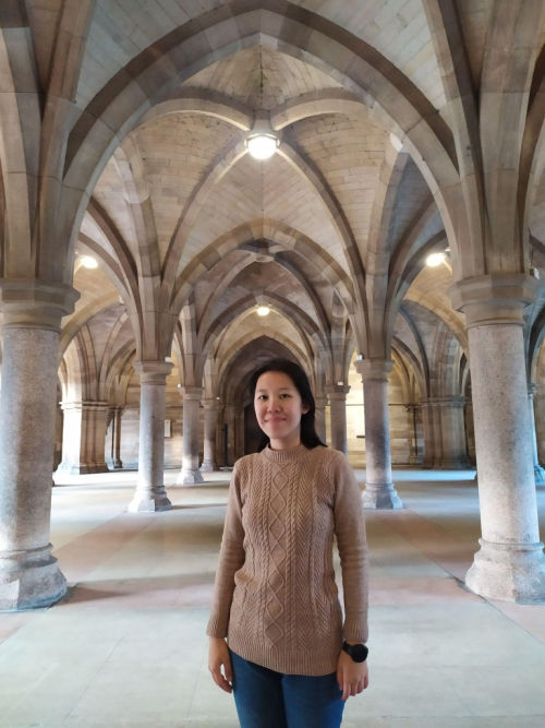 Felicia Iona Roselyn stood in the University Cloisters