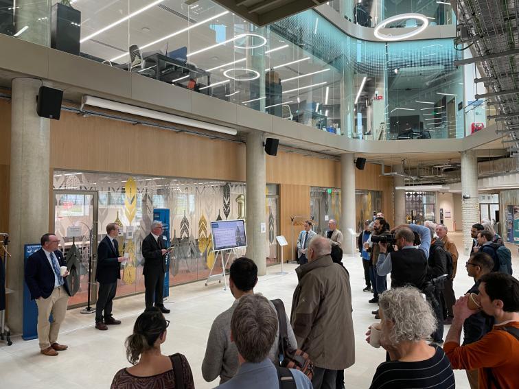 Audience standing with Graeme Roy and another speaker discussing in the foyer at the Advanced Research Centre Source: Claire Martin, College of Social Sciences